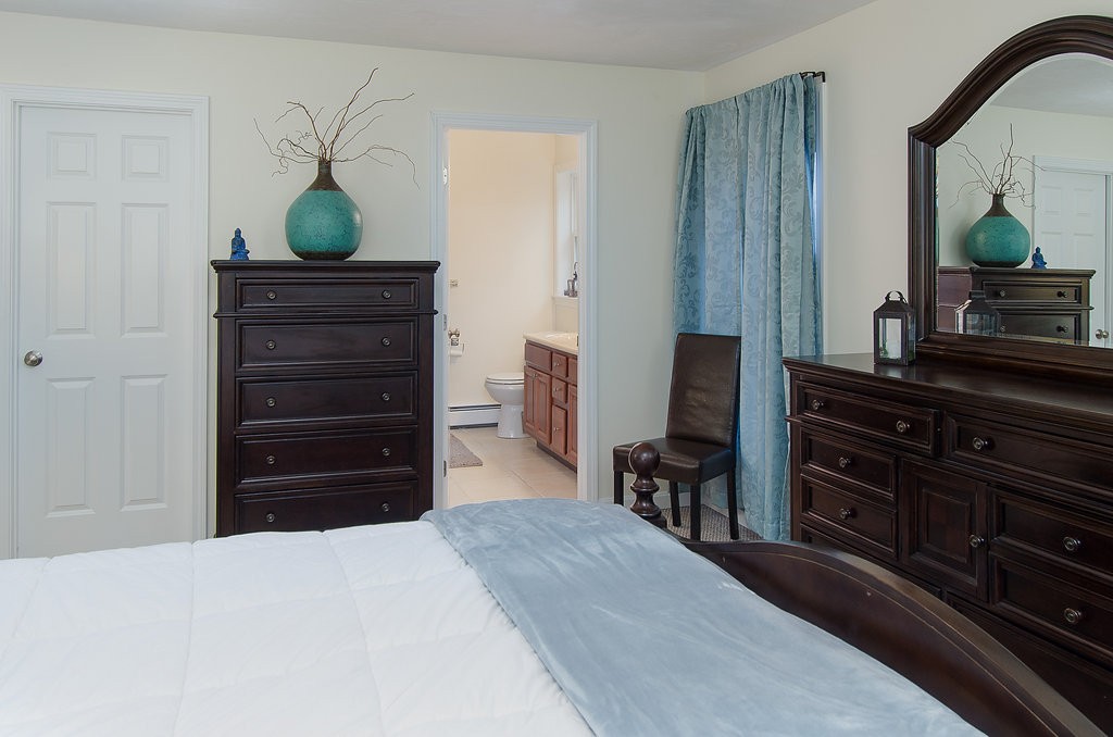 2 Sterling Lane, Unit 2 Walpole, MA 02081 - Photo 17 of 27 a bedroom with a bed and a dresser