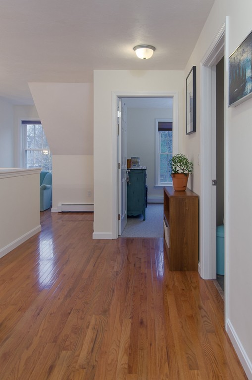 2 Sterling Lane, Unit 2 Walpole, MA 02081 - Photo 19 of 27 a view of a living room and hallway with wooden floor