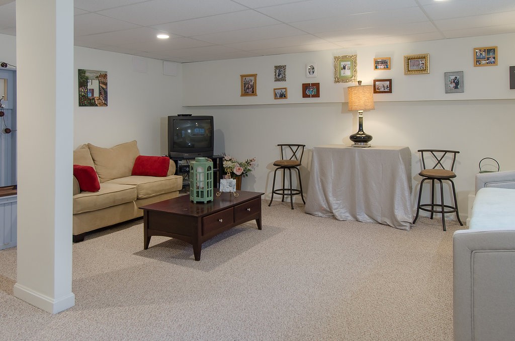 2 Sterling Lane, Unit 2 Walpole, MA 02081 - Photo 22 of 27 a living room with furniture and a couch