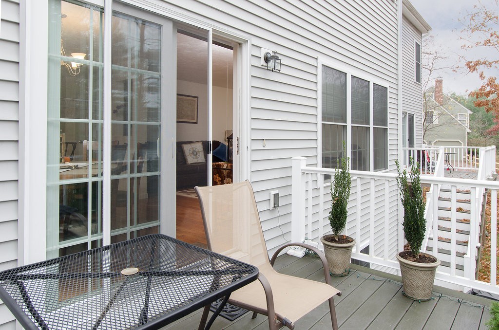 2 Sterling Lane, Unit 2 Walpole, MA 02081 - Photo 24 of 27 a balcony with table and chairs