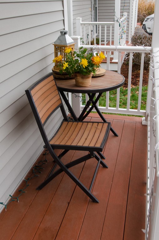 2 Sterling Lane, Unit 2 Walpole, MA 02081 - Photo 25 of 27 a roof deck with table and chairs and potted plants