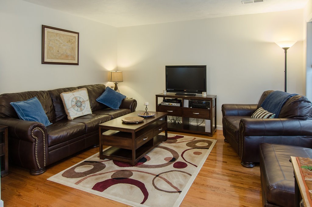 2 Sterling Lane, Unit 2 Walpole, MA 02081 - Photo 7 of 27 a living room with furniture and a flat screen tv
