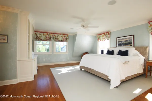 a bedroom with a large bed and a chandelier