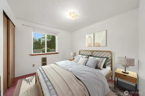 a bedroom with a bed and a window