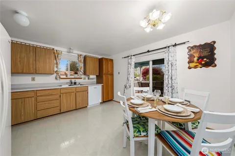 a kitchen with a table chairs a stove and a refrigerator