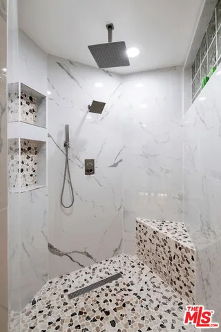 a spacious bedroom with a bed and wooden floor