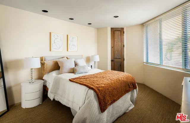 a bathroom with a granite countertop sink mirror vanity and toilet