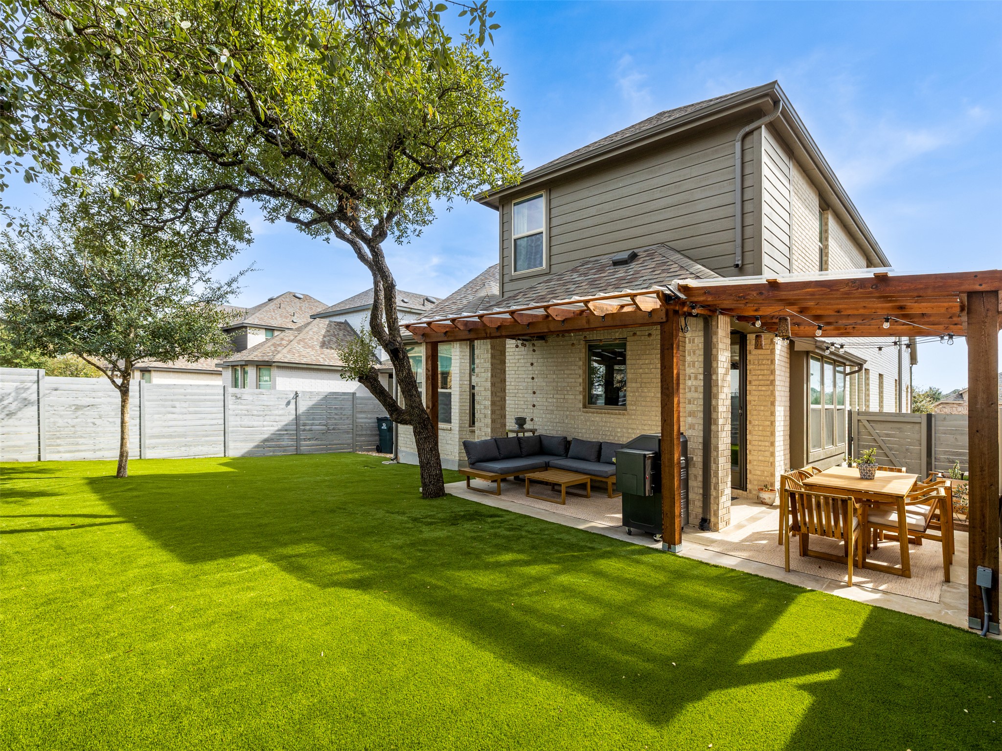 a view of a house with backyard porch and sitting area