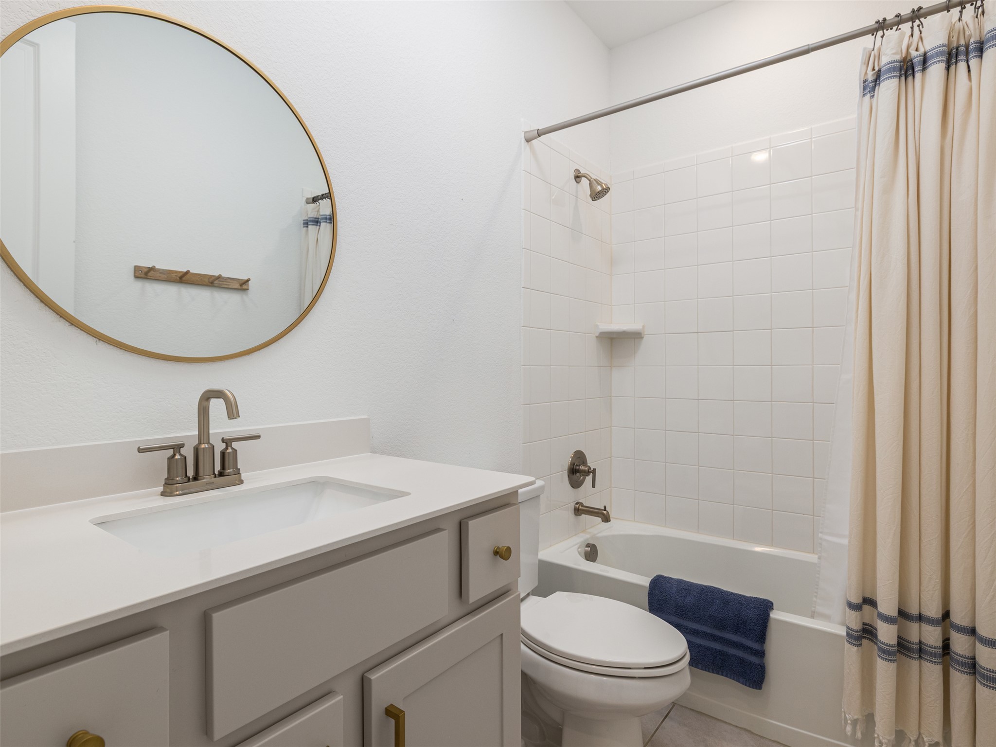 233 Arrowhead Mound Road Georgetown, TX 78628 - Photo 15 of 40 Bathroom with vanity and shower / tub combo with curtain