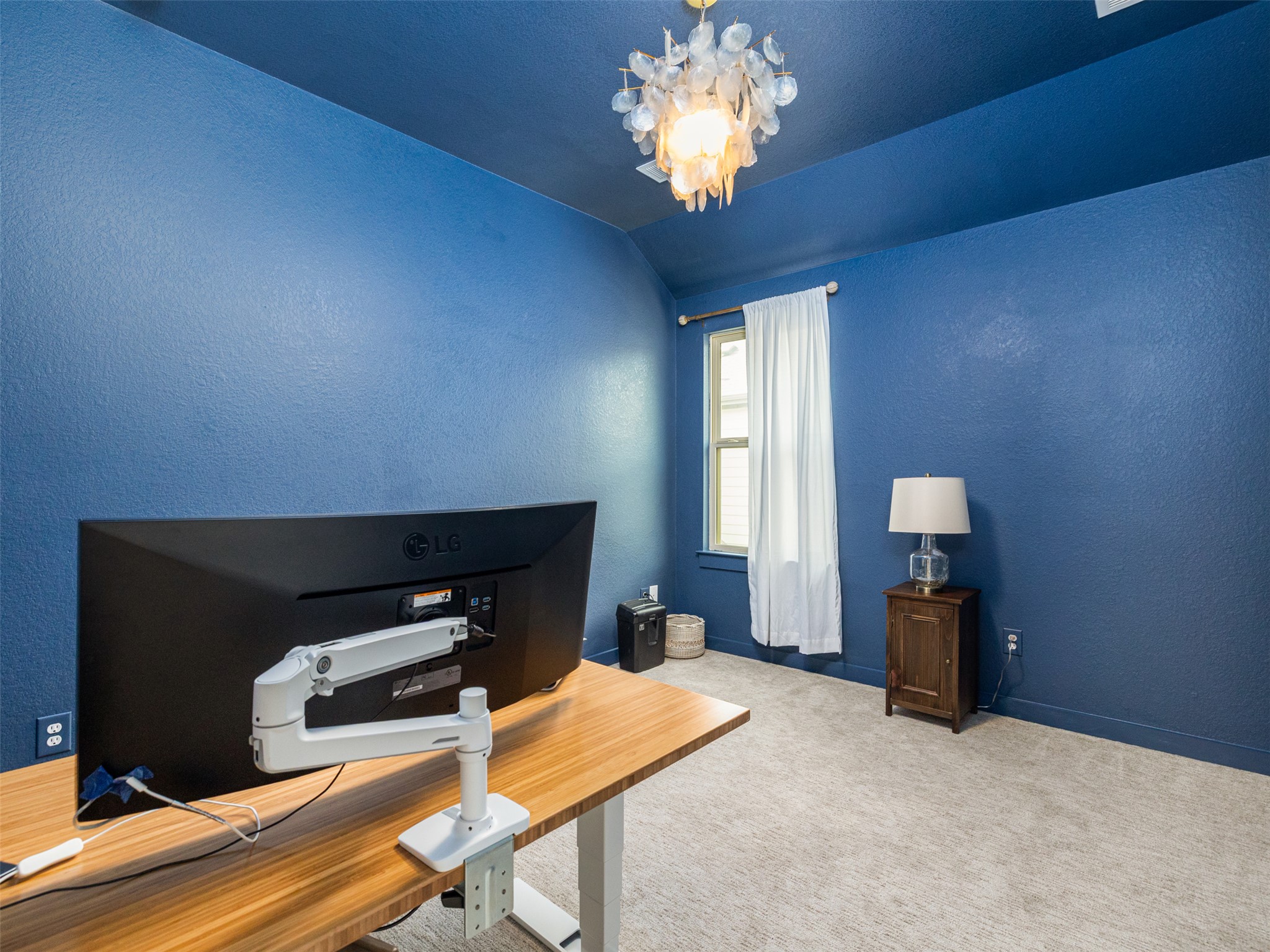 233 Arrowhead Mound Road Georgetown, TX 78628 - Photo 19 of 40 Office area featuring a textured wall, carpet, a chandelier, and vaulted ceiling