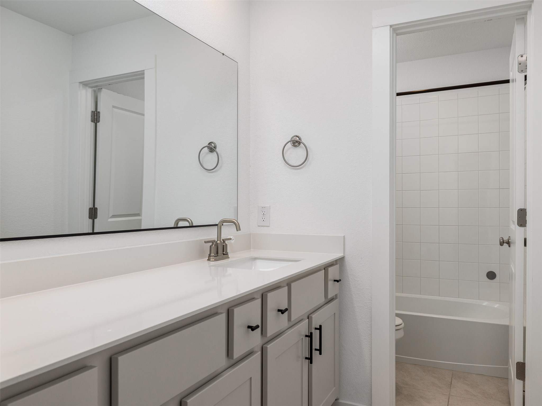 233 Arrowhead Mound Road Georgetown, TX 78628 - Photo 20 of 40 Full bath featuring vanity, light tile patterned flooring, and shower / washtub combination