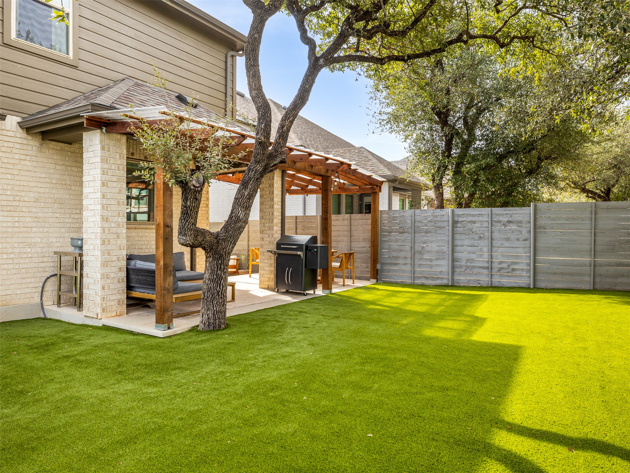 233 Arrowhead Mound Road Georgetown, TX 78628 - Photo 25 of 40 Fenced yard with a patio and a pergola