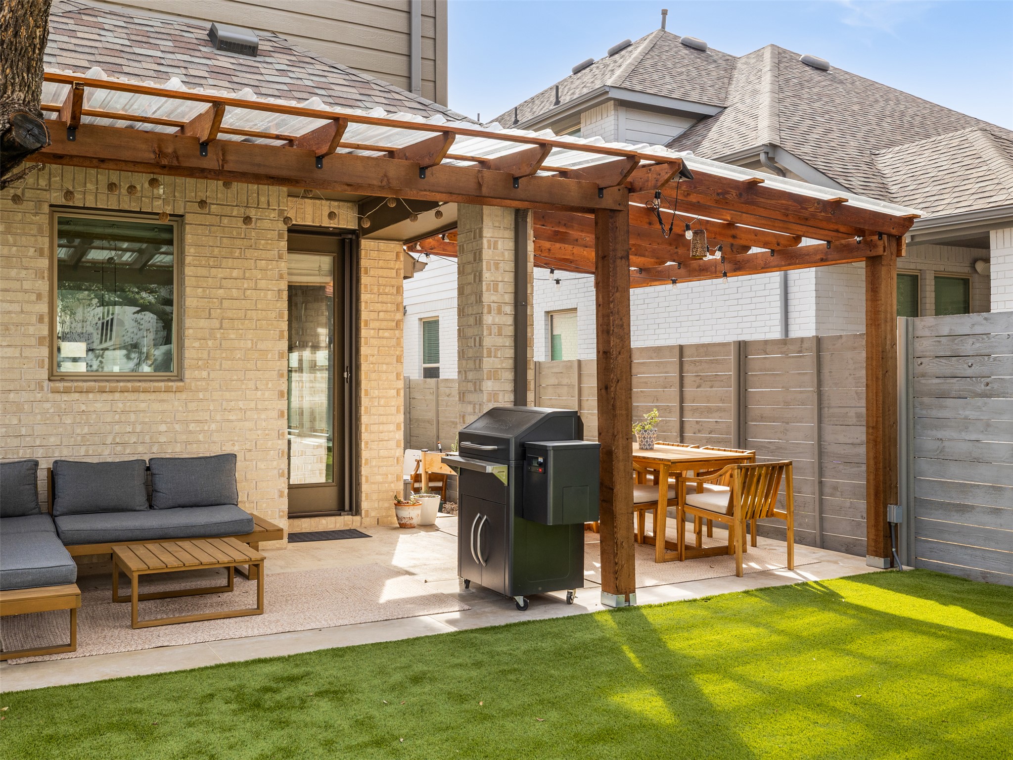 233 Arrowhead Mound Road Georgetown, TX 78628 - Photo 27 of 40 View of patio / terrace featuring an outdoor living / dining area, a pergola, and area for grilling