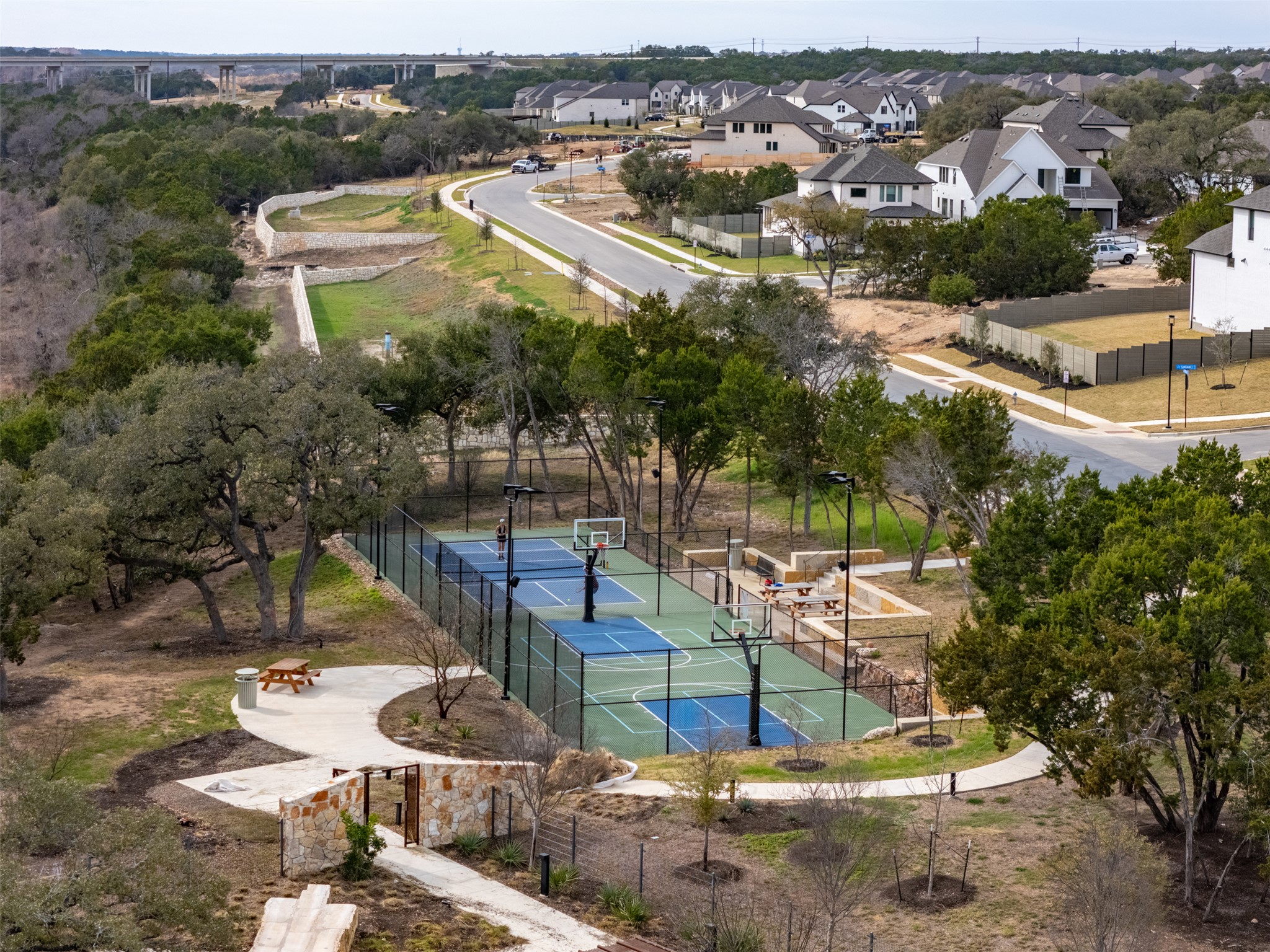 233 Arrowhead Mound Road Georgetown, TX 78628 - Photo 35 of 40 View of tennis court with a residential view