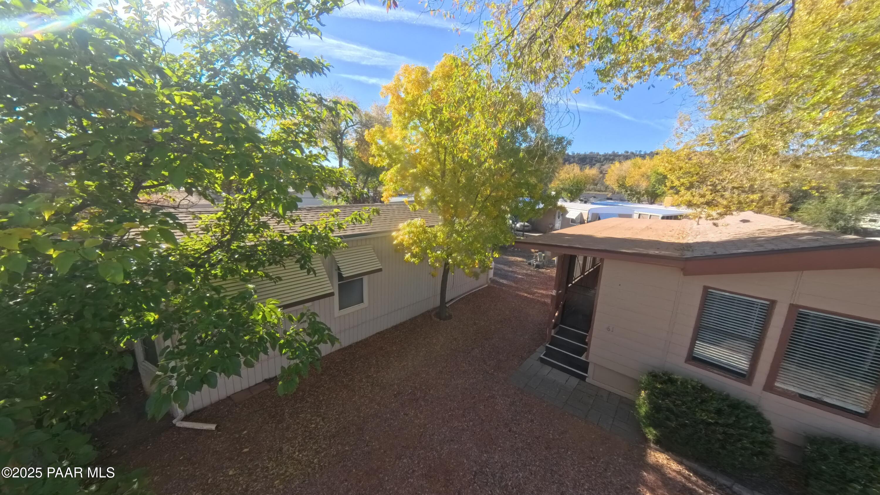11250 East State Rte 69, Unit 61 Prescott Valley, AZ 86314 - Photo 26 of 41 a view of a patio with table and chairs and potted plants