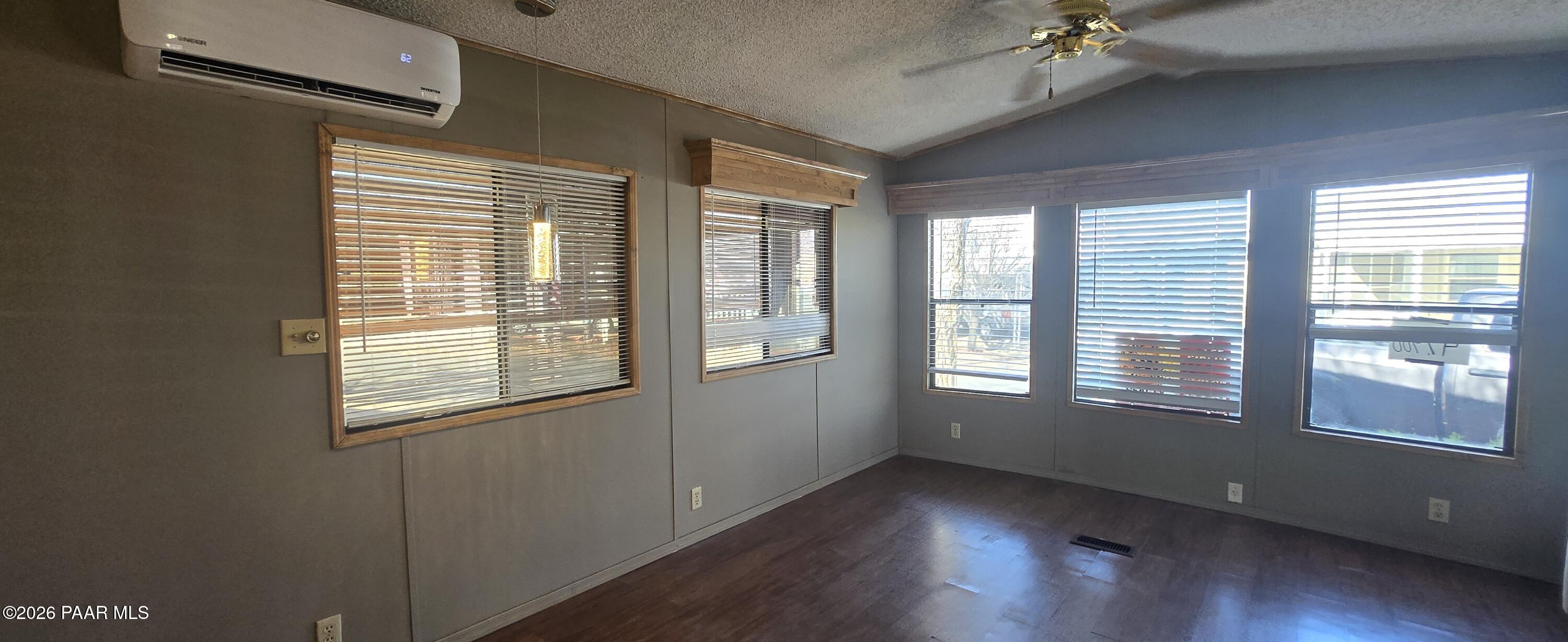 11250 East State Rte 69, Unit 61 Prescott Valley, AZ 86314 - Photo 7 of 41 a view of an empty room with wooden floor and a window
