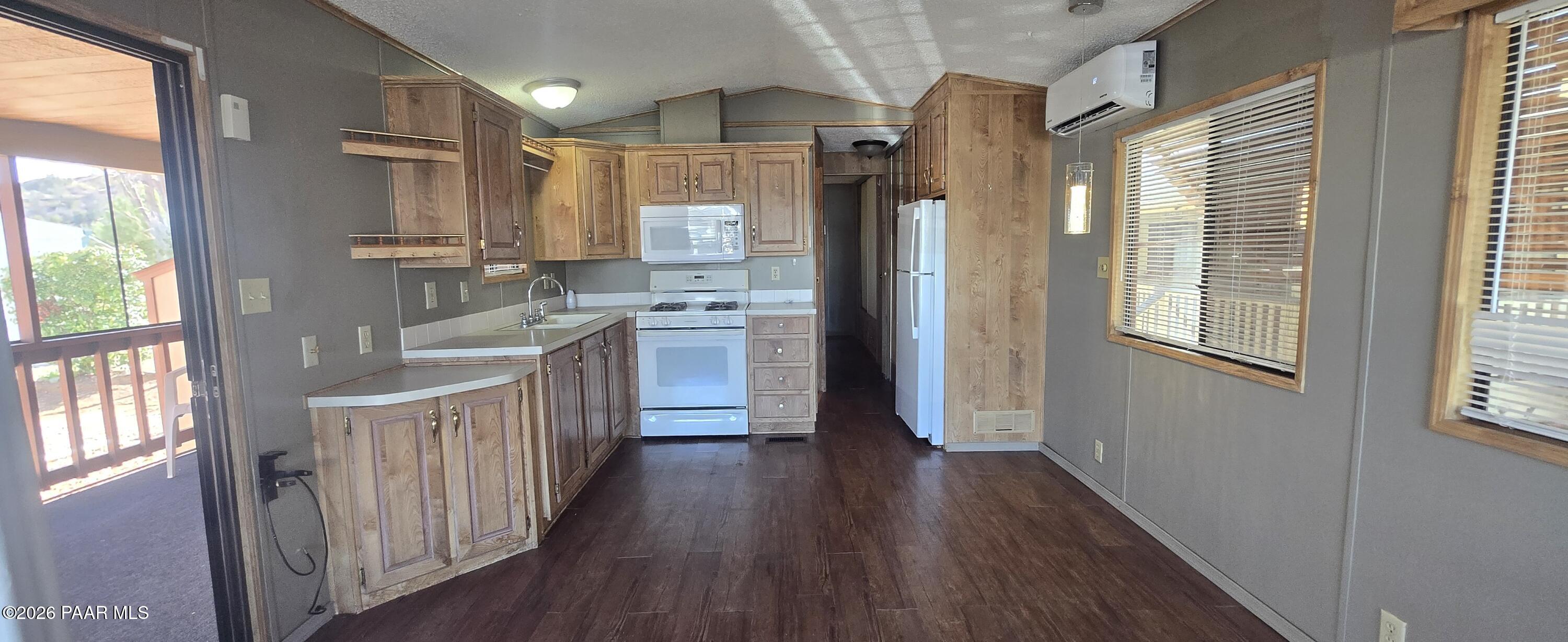 11250 East State Rte 69, Unit 61 Prescott Valley, AZ 86314 - Photo 8 of 41 a kitchen with stainless steel appliances a refrigerator and wooden floor