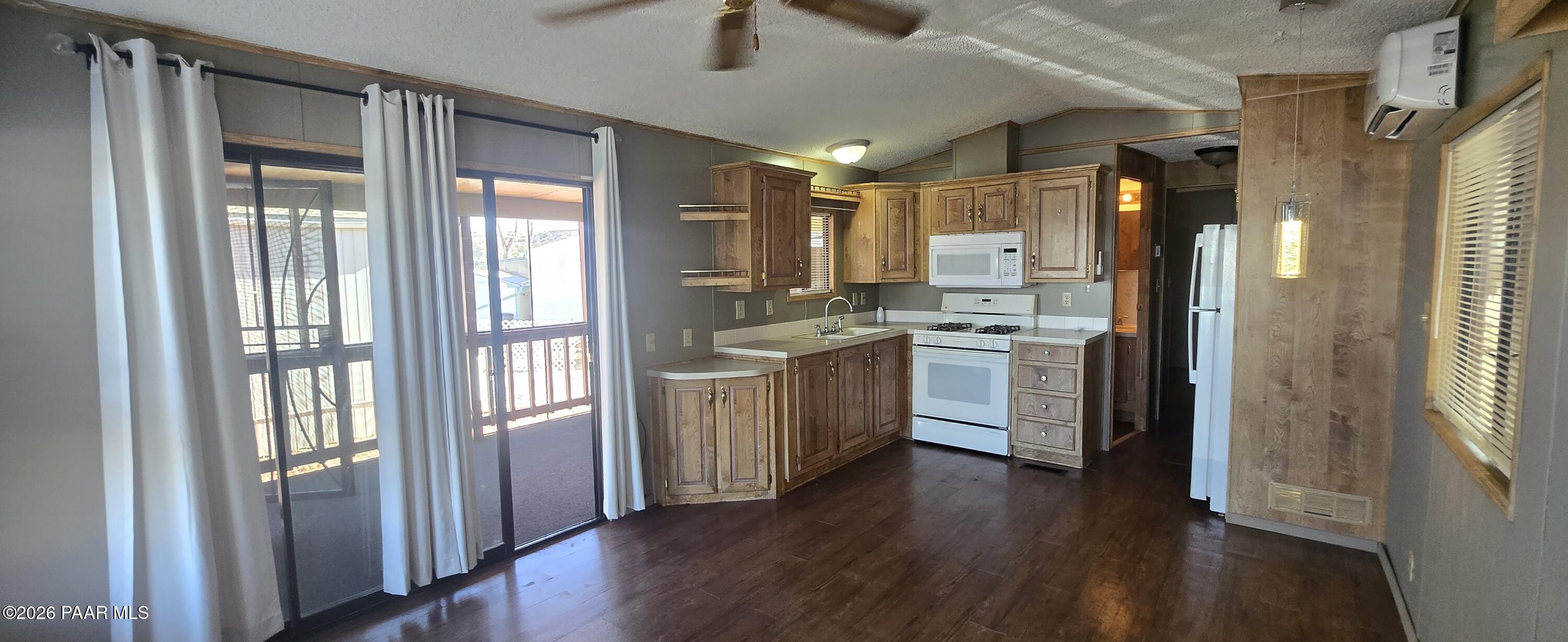 11250 East State Rte 69, Unit 61 Prescott Valley, AZ 86314 - Photo 10 of 41 a kitchen with a stove a refrigerator and a view of living room