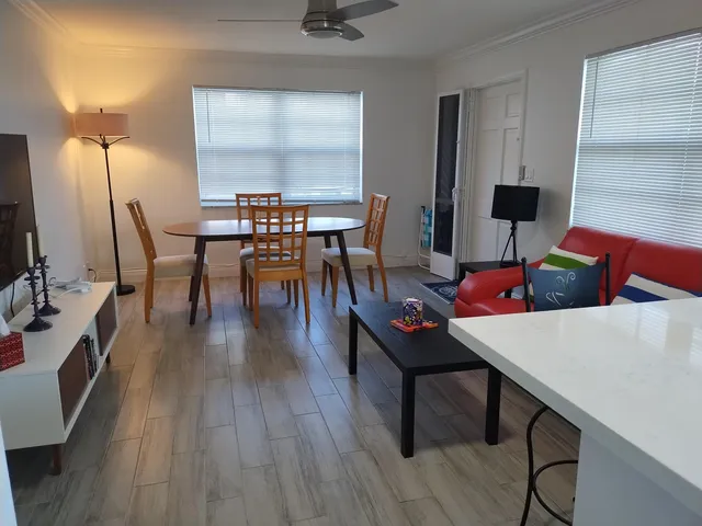 a view of a dining room with furniture and wooden floor