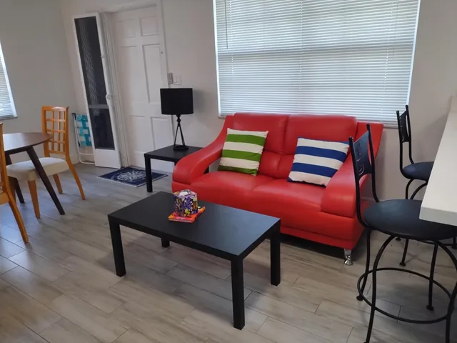 a living room with furniture and a lamp