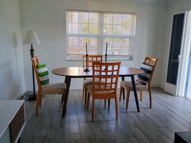 a dining room with furniture and wooden floor