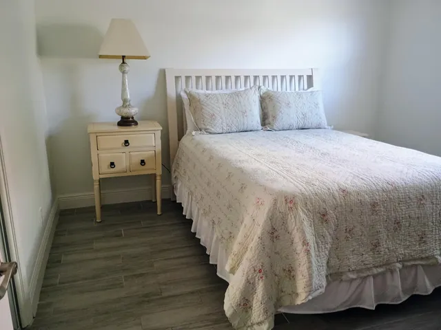 a spacious bedroom with a bed and a window