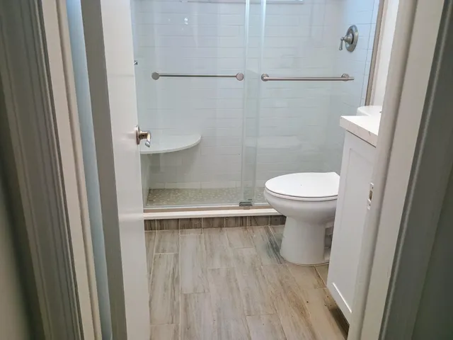 a bathroom with a toilet and a shower