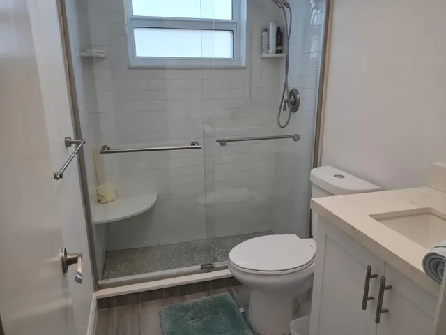 a bathroom with a toilet and a shower