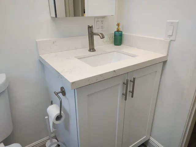 a bathroom with a sink and mirror
