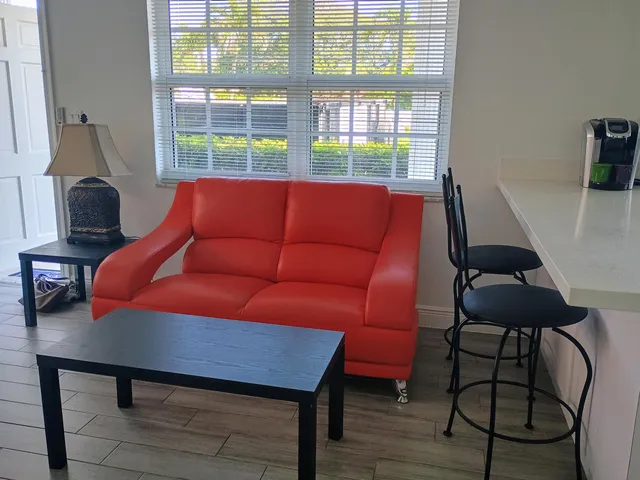 a blue chair sitting in a room next to a window