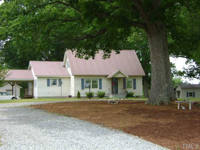 1100 Tatum Road Roxboro, NC 27574 - Photo 2 of 10 front view of a house with a yard