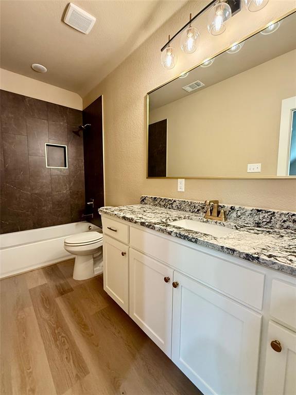 114 Ridgeline Drive Chico, TX 76431 - Photo 14 of 23 a bathroom with a granite countertop sink mirror and toilet