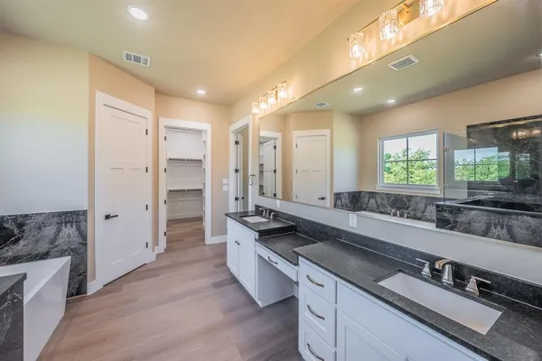 a kitchen with a refrigerator sink and cabinets