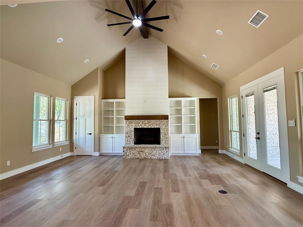 114 Ridgeline Drive Chico, TX 76431 - Photo 4 of 23 a view of an empty room with wooden floor and a window