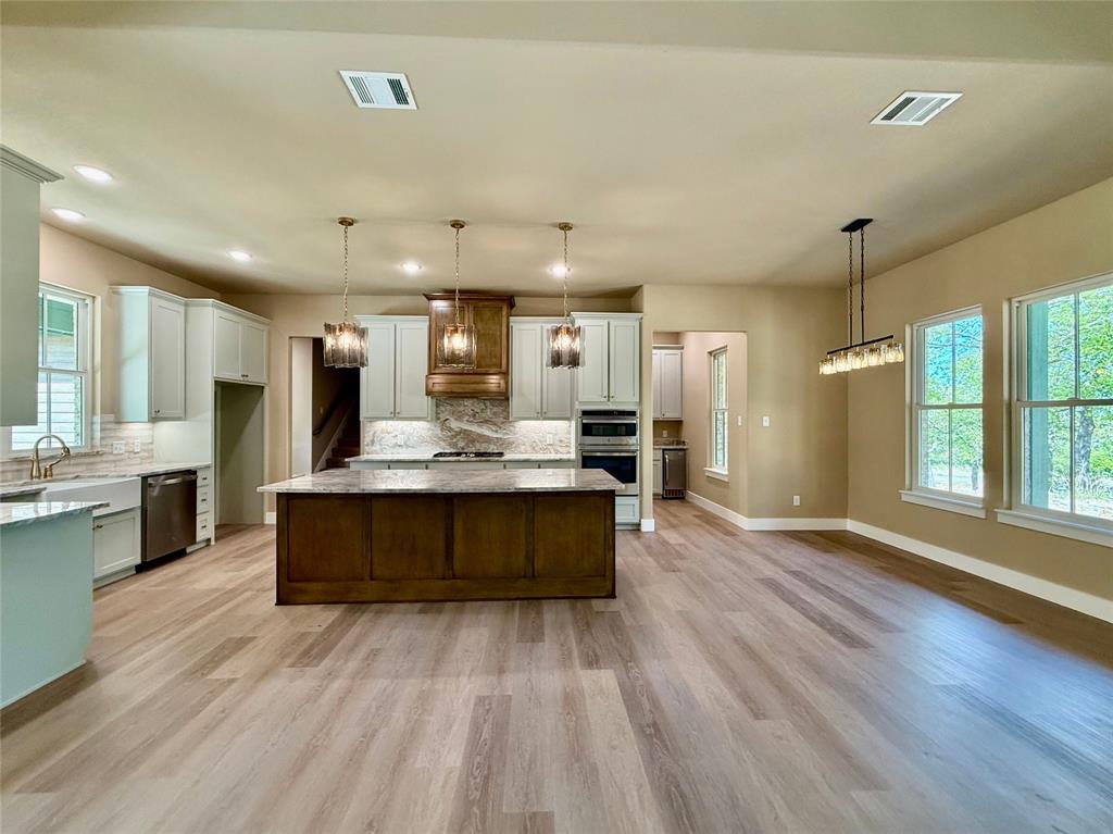 114 Ridgeline Drive Chico, TX 76431 - Photo 6 of 23 a large kitchen with kitchen island a sink stainless steel appliances and cabinets
