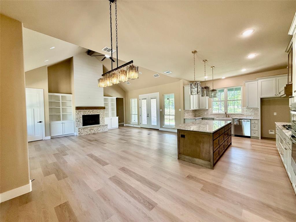 114 Ridgeline Drive Chico, TX 76431 - Photo 7 of 23 a large living room with stainless steel appliances granite countertop furniture and a fireplace