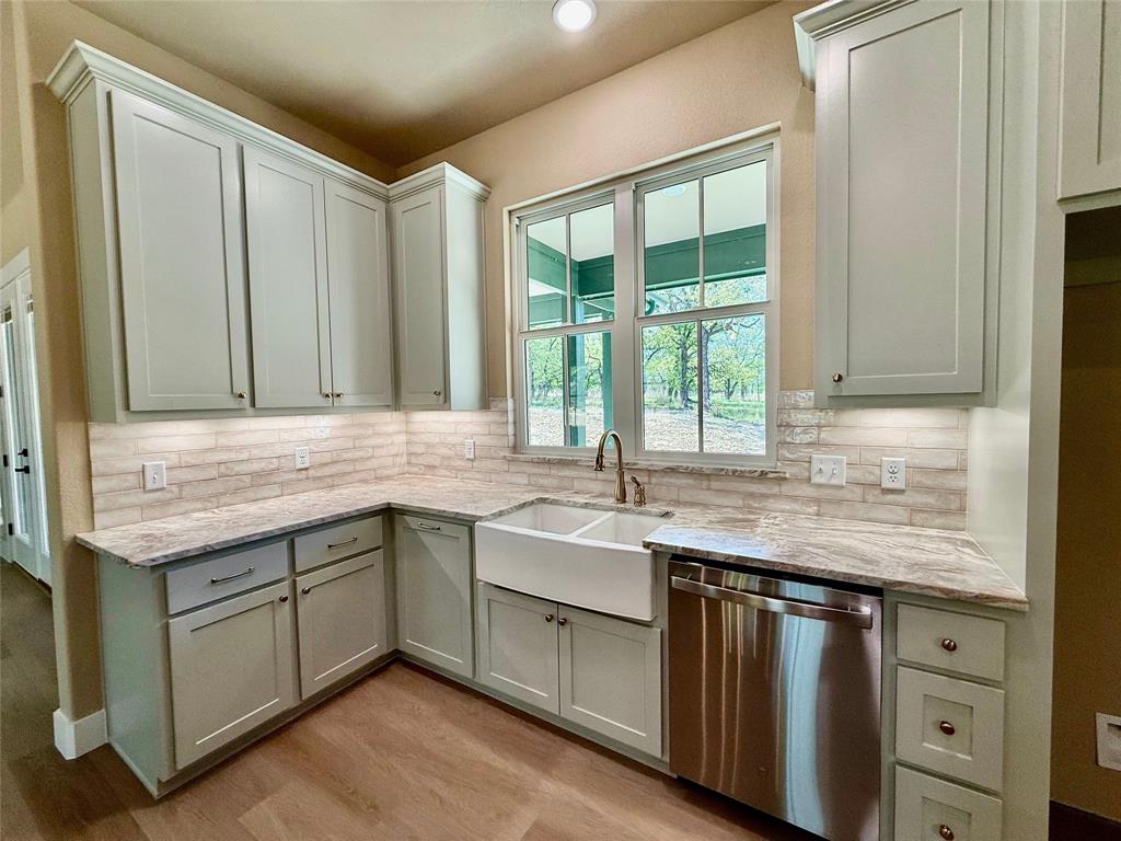 114 Ridgeline Drive Chico, TX 76431 - Photo 9 of 23 a kitchen with a sink stove and cabinets