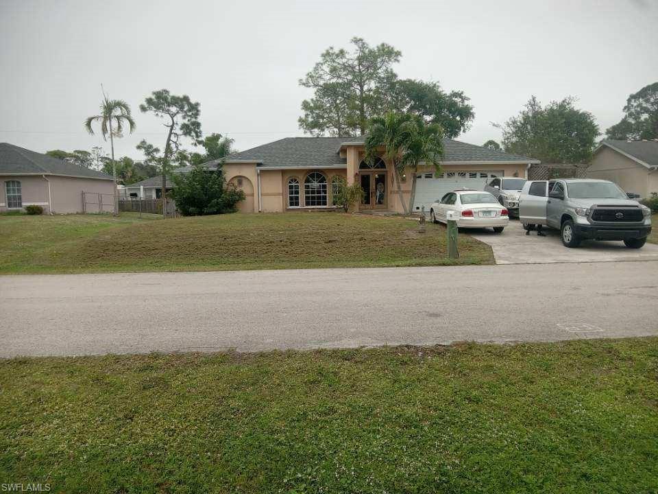 8213 Albatross Road Fort Myers, FL 33967 - Photo 1 of 17 a view of house with outdoor space and parking