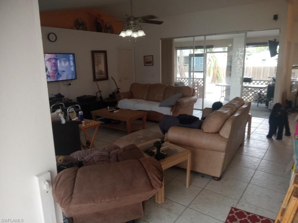 8213 Albatross Road Fort Myers, FL 33967 - Photo 5 of 17 a living room with furniture and a large window