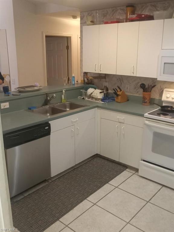 8213 Albatross Road Fort Myers, FL 33967 - Photo 6 of 17 a kitchen with a sink stove and cabinets