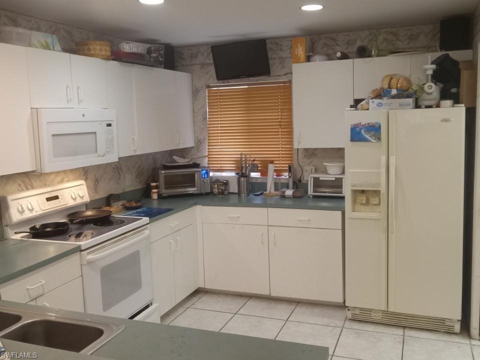 8213 Albatross Road Fort Myers, FL 33967 - Photo 8 of 17 a kitchen with appliances cabinets and a sink