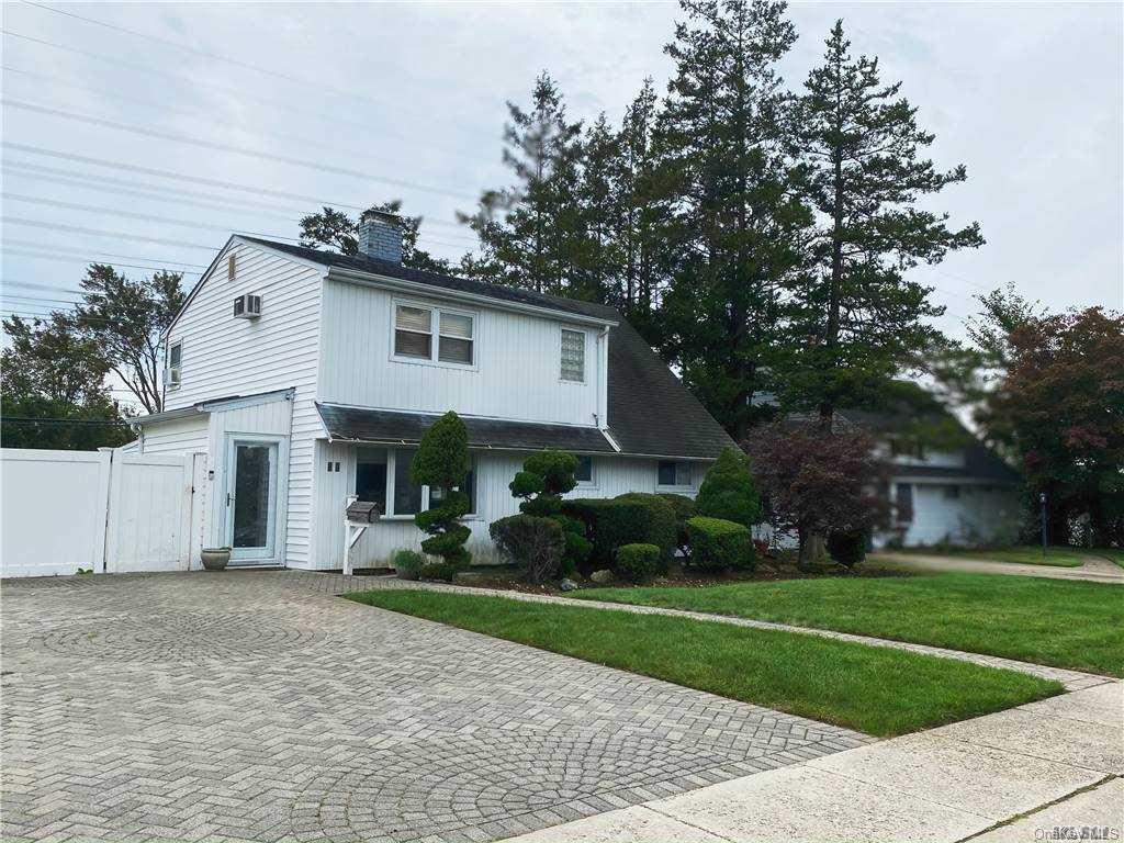 48 Meridian Road Levittown, NY 11756 - Photo 1 of 1 a front view of house with yard and green space