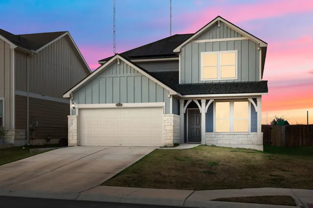 a front view of a house with garage