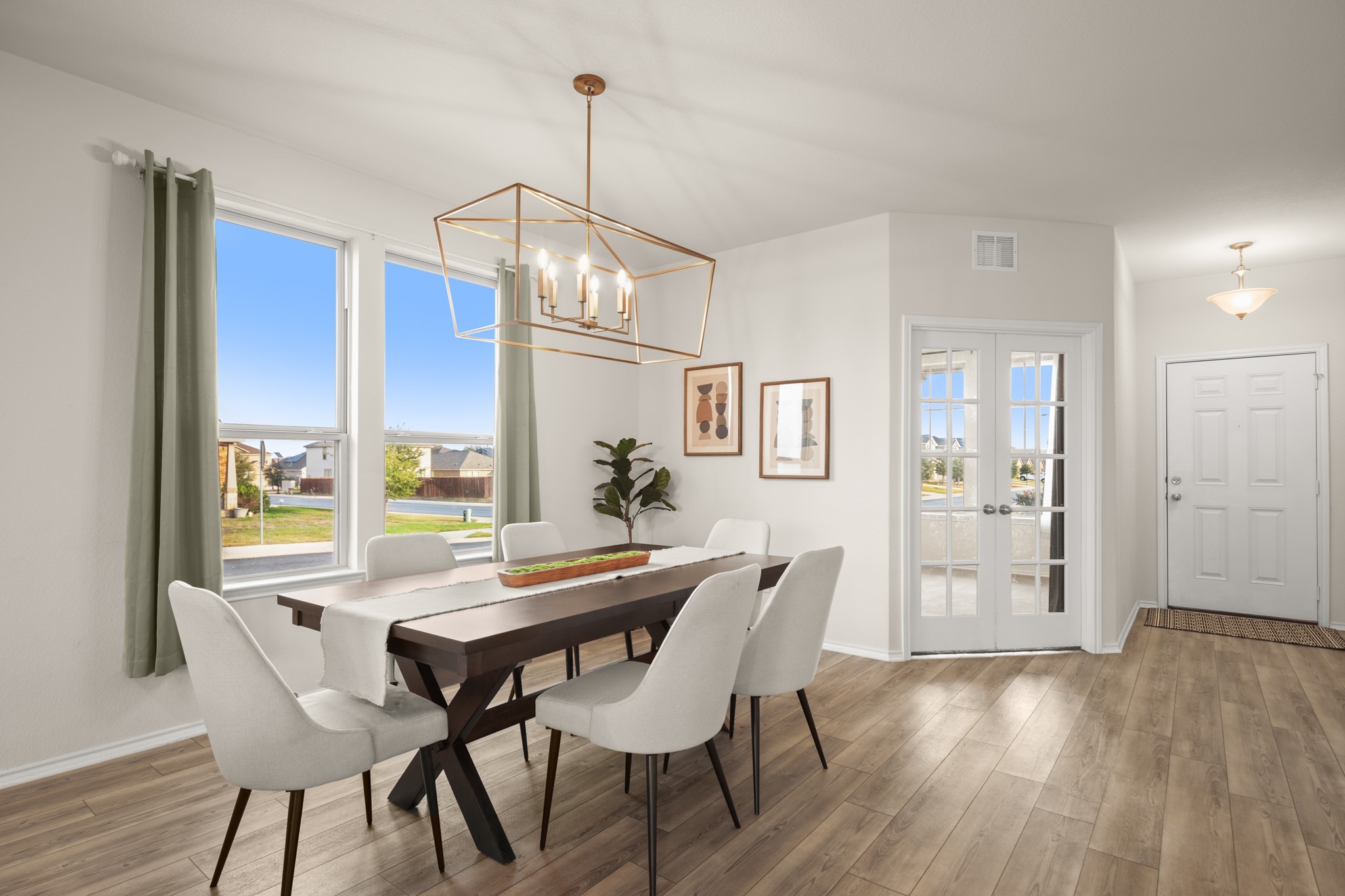 2300 Cliffbrake Way Georgetown, TX 78626 - Photo 3 of 28 a dining room with furniture a chandelier and wooden floor