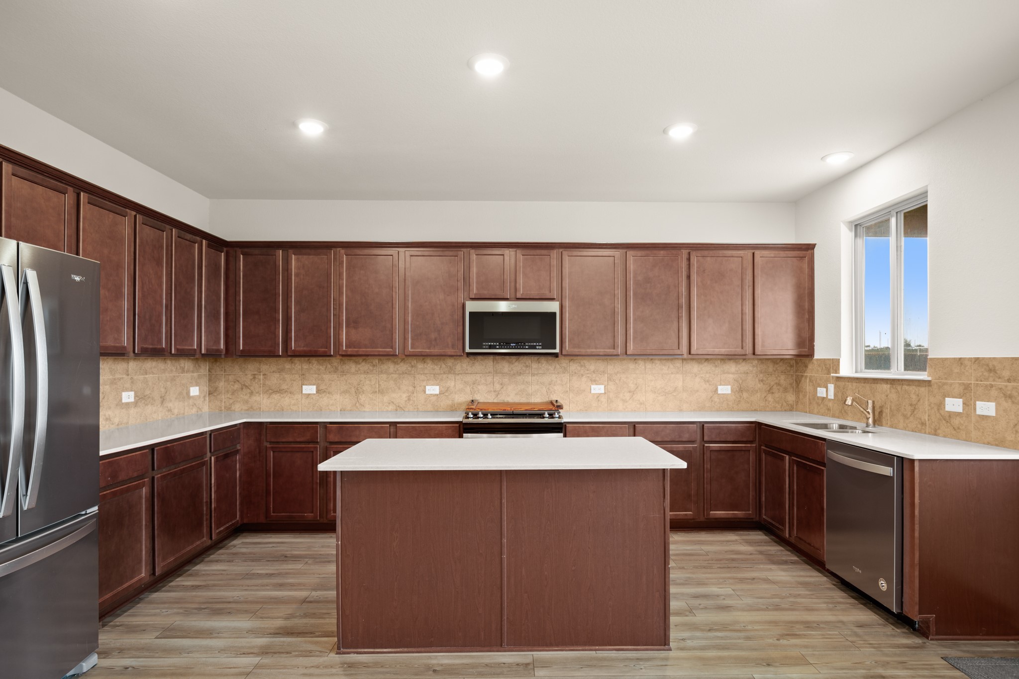 2300 Cliffbrake Way Georgetown, TX 78626 - Photo 9 of 28 a kitchen with stainless steel appliances granite countertop a sink stove and refrigerator
