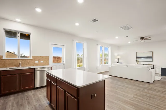 a large kitchen with a center island and stainless steel appliances