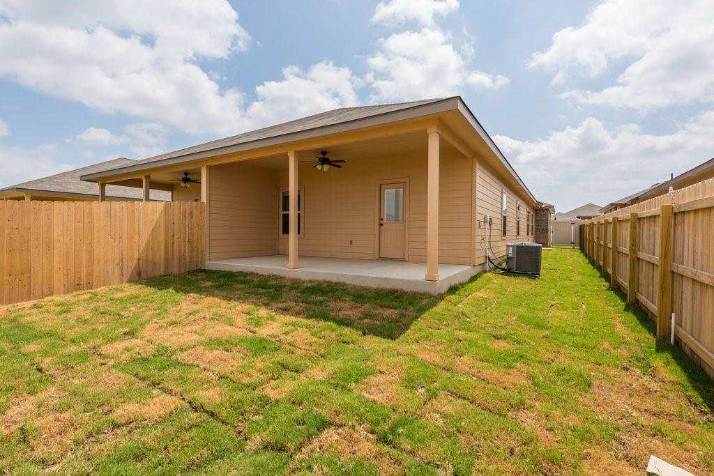 491 Jack Rabbit Lane, Unit A Buda, TX 78610 - Photo 19 of 22 A spacious covered patio overlooks a newly sodded private yard, perfect for outdoor living.