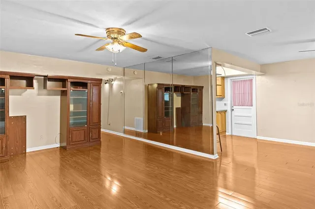 a view of an empty room with a fireplace and a window