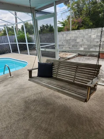 a view of a backyard with a swimming pool