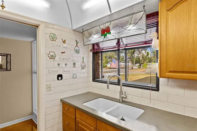 a kitchen with stainless steel appliances granite countertop wooden cabinets and a stove top oven